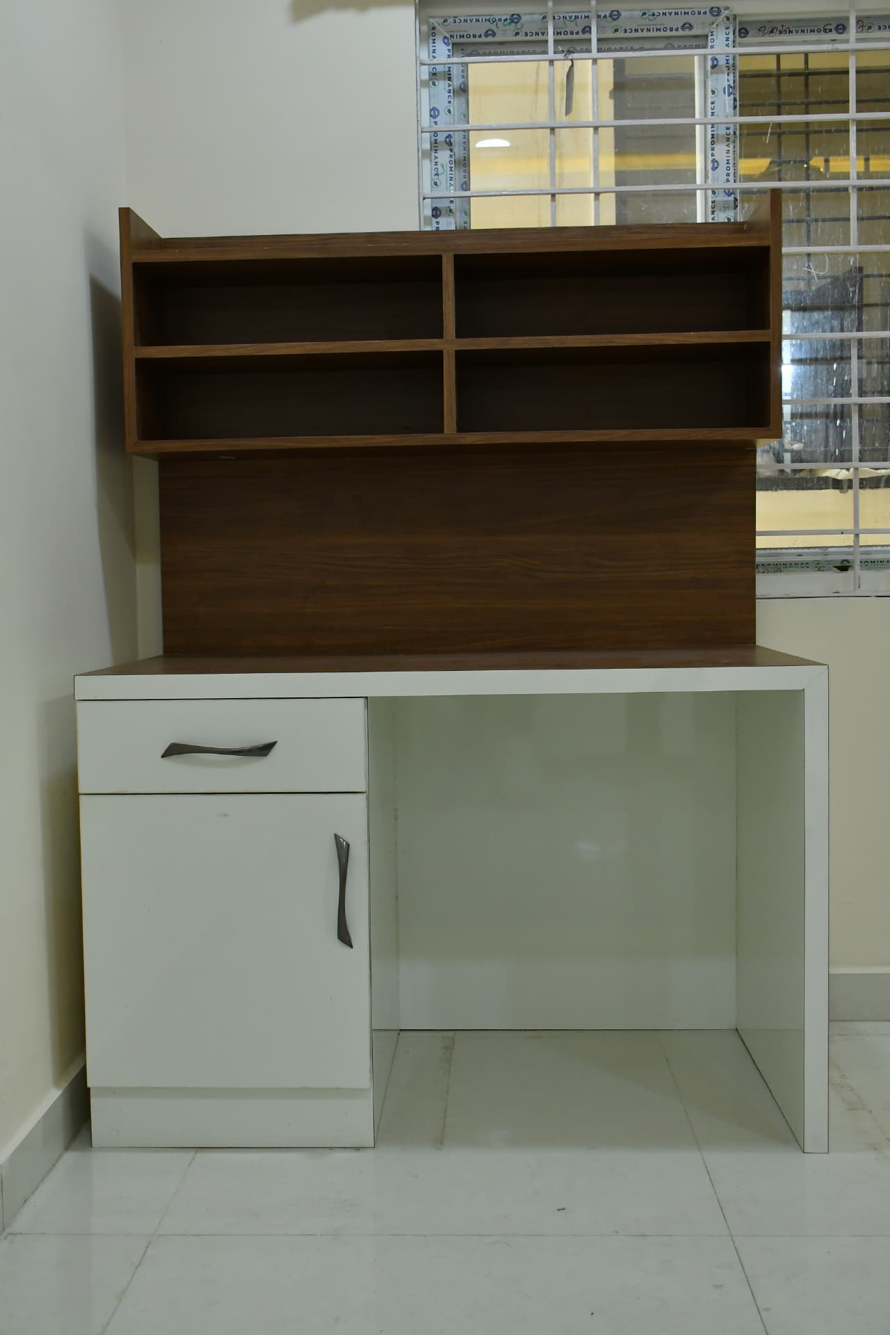 Mrs. Vasundara's Residence, Ballari — Compact study desk with wall-mounted open shelving in walnut and white
