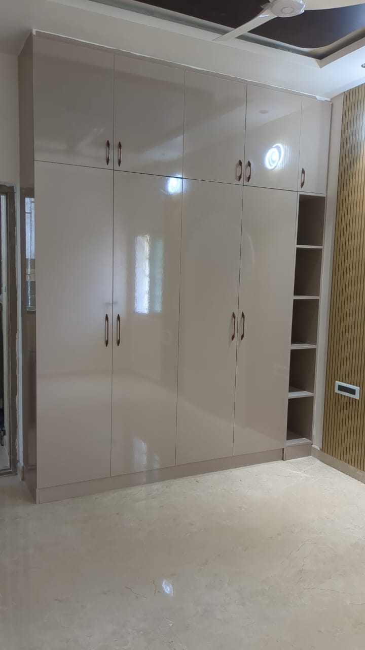 Ajay's House, Ballari — Glossy laminate wardrobe with open display shelving
