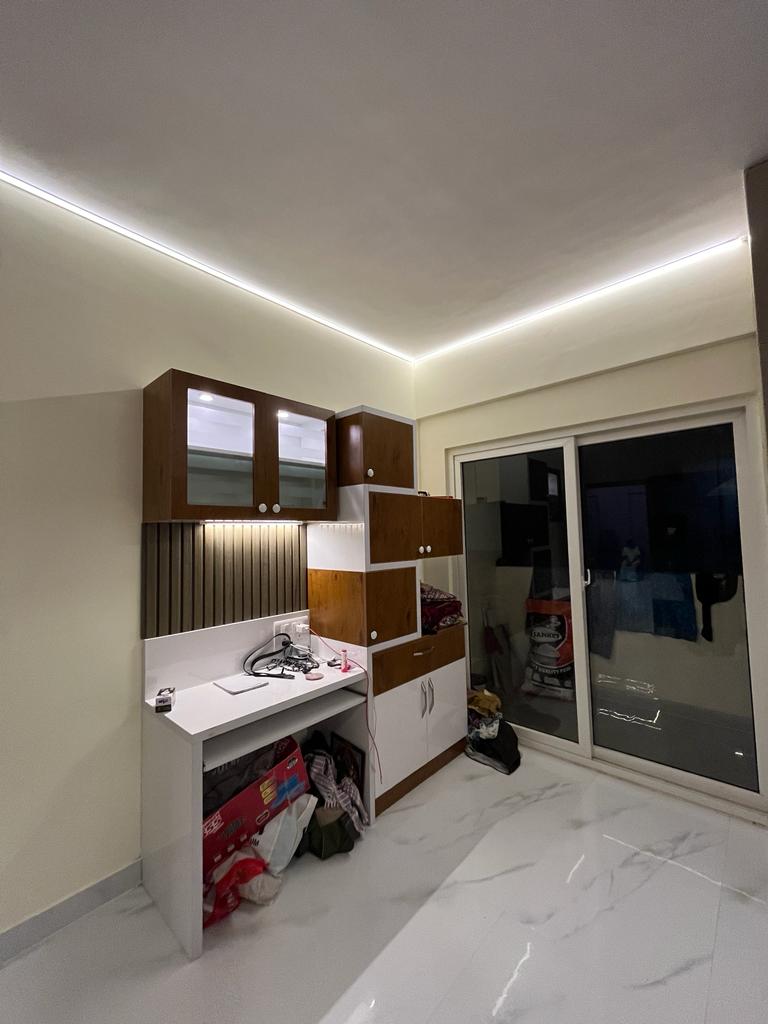 Rohan's Flat, Bangalore — Study and dressing nook with wood-and-white storage and concealed cove lighting