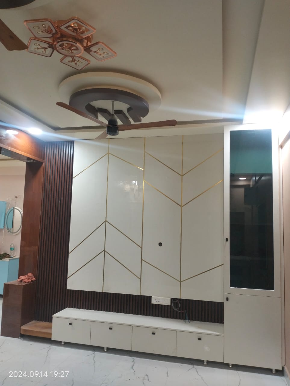 Manibhushan's House, Hyderabad — TV unit with gold-inlay chevron panelling and fluted wood column