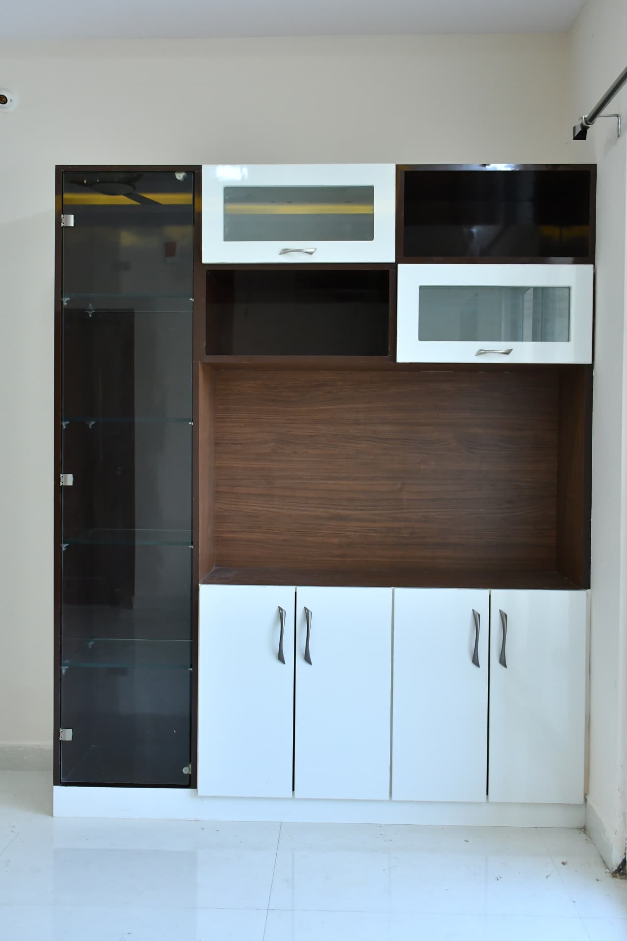 Mrs. Vasundara's Residence, Ballari — Crockery unit in walnut and white with glass display shutters and tinted glass cabinet