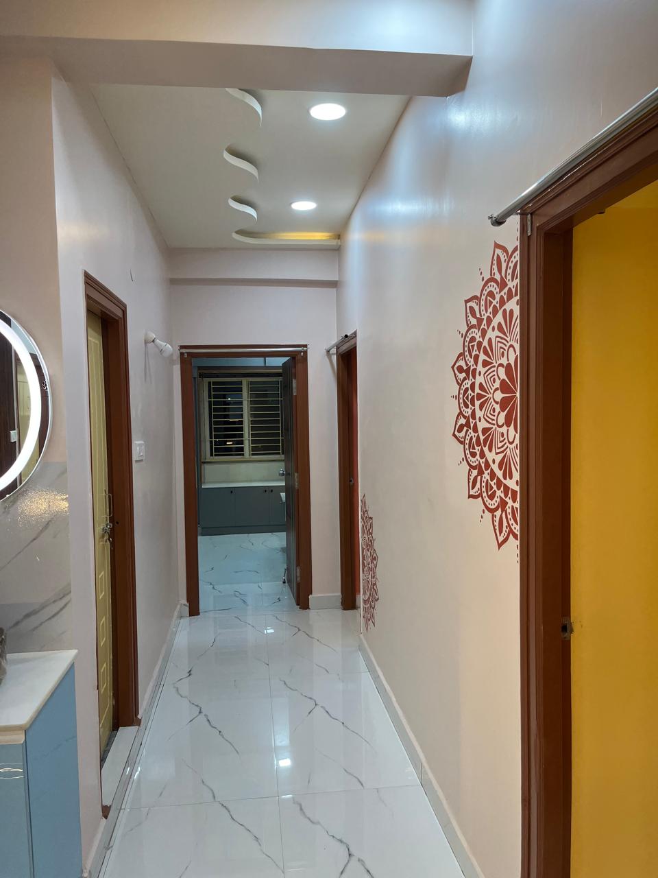 Manibhushan's House, Hyderabad — Corridor with mandala wall art and curved ceiling detail
