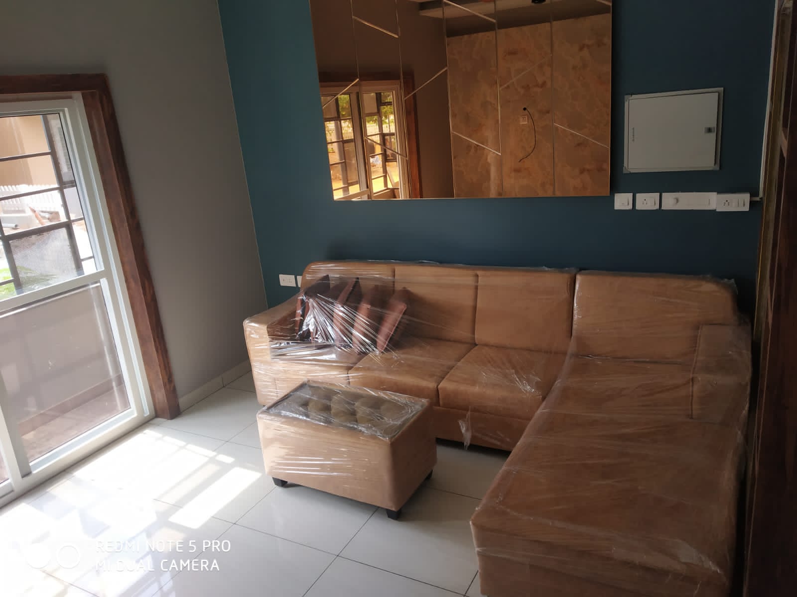 Umer's Residence, Bengaluru — Living room seating against the teal accent wall with mirror panelling